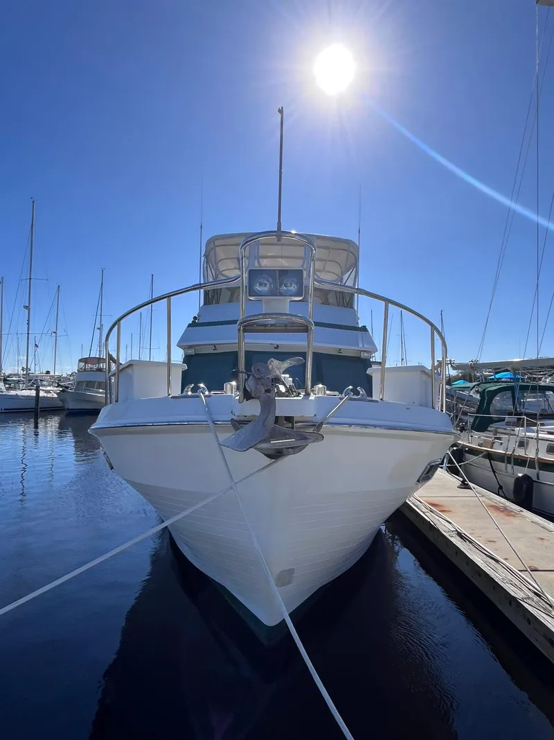 Slide: The Image of 1989 CHB Oceania 42 yacht docked under bright sun in marina. - 8