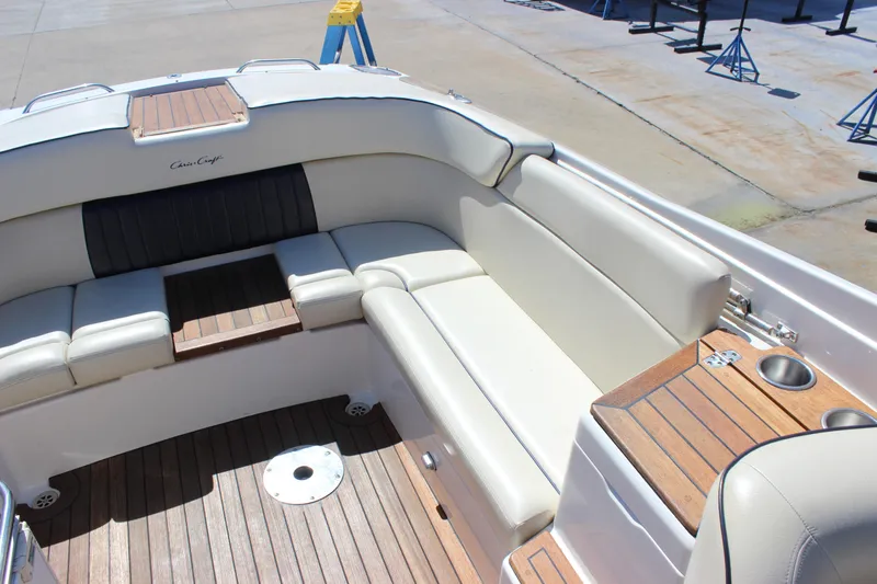 Slide: The Image of 2004 Chris-Craft Corsair 25 boat interior with white seating and wooden accents. - 15