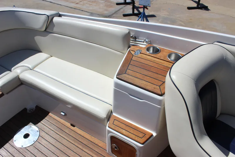 Slide: The Image of 2004 Chris-Craft Corsair 25 interior with beige seating and wooden accents. - 23