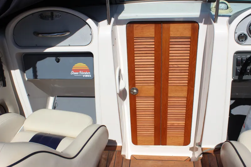 Slide: The Image of 2004 Chris-Craft Corsair 25 interior with wooden door and seating. - 25