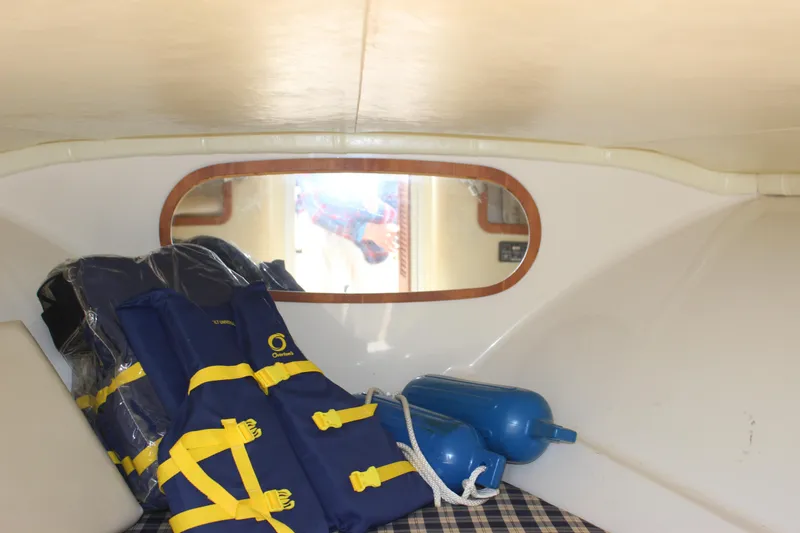 Slide: The Image of 2004 Chris-Craft Corsair 25 cabin interior with life jackets and fenders. - 26