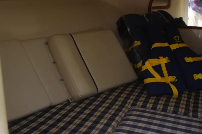 Slide: The Image of Interior cabin of 2004 Chris-Craft Corsair 25 with cushions and life jackets. - 28