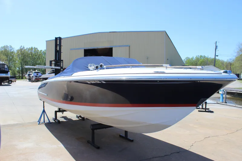 Slide: The Image of 2004 Chris-Craft Corsair 25 boat on display outside a warehouse. - 3