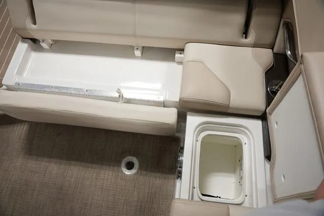 Slide: The Image of 2016 Formula 290 Bowrider interior storage compartments with beige seating and carpeted flooring. - 12
