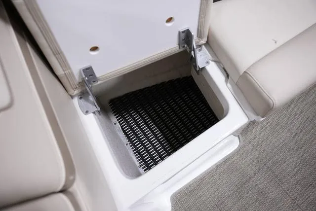Slide: The Image of 2016 Formula 290 Bowrider storage compartment with open lid and black mat inside. - 24