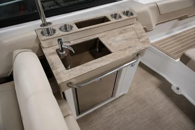Slide: The Image of 2016 Formula 290 Bowrider boat interior with sink and cup holders. - 9