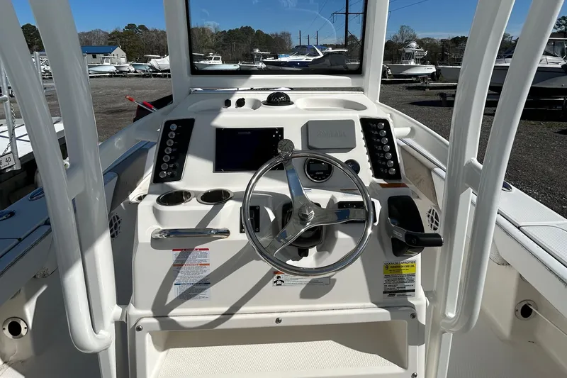 Slide: The Image of 2021 Robalo 246 Cayman boat helm with steering wheel and control panel. - 21