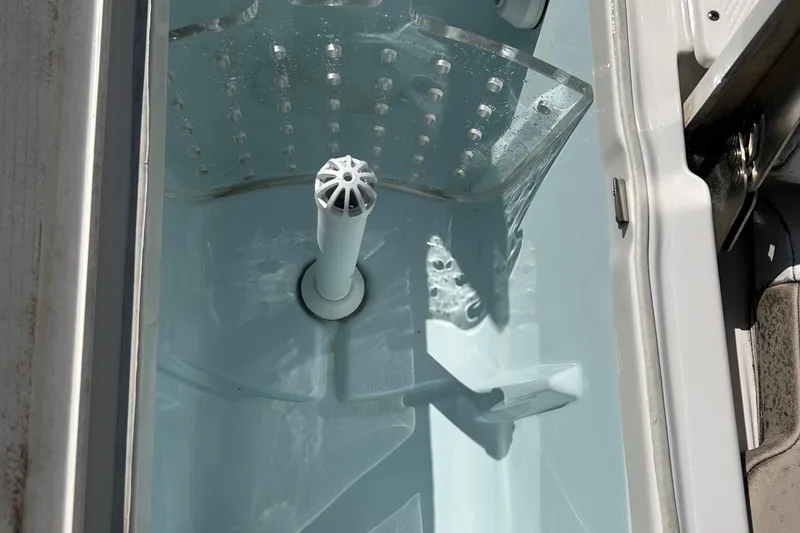 Slide: The Image of Livewell tank in a 2021 Robalo 246 Cayman boat, filled with water. - 23