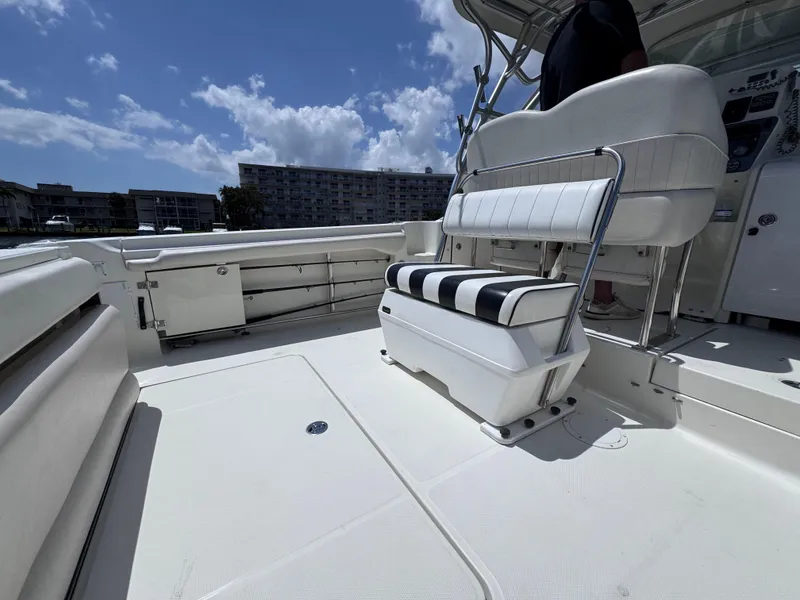 Slide: The Image of 2006 Hydra-Sports 33VX boat interior with white seating and clear sky background. - 10