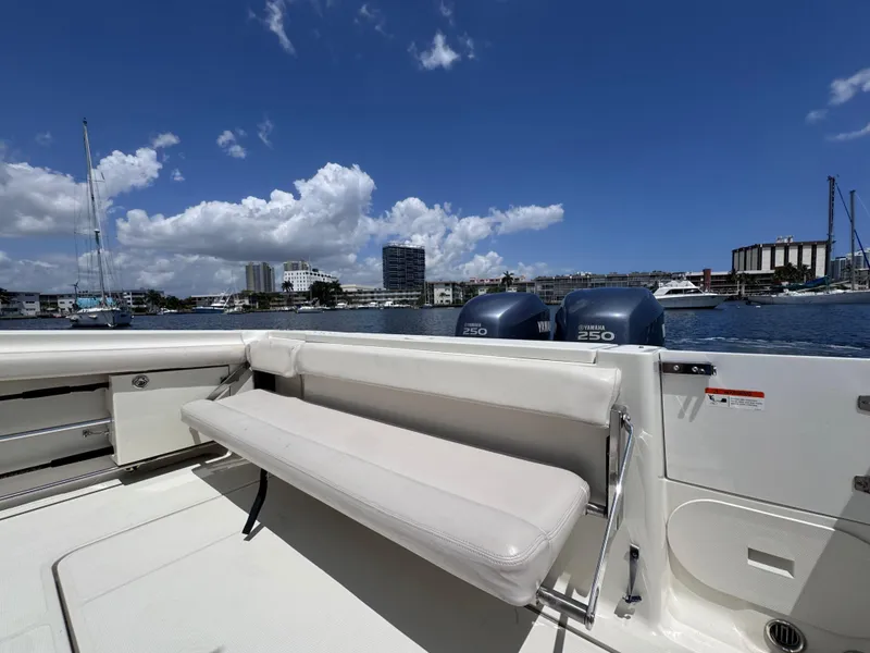 Slide: The Image of 2006 Hydra-Sports 33VX boat with seating, twin engines, and marina view under blue sky. - 12