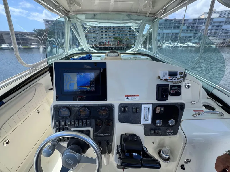 Slide: The Image of 2006 Hydra-Sports 33VX boat dashboard with navigation screen and controls. - 13
