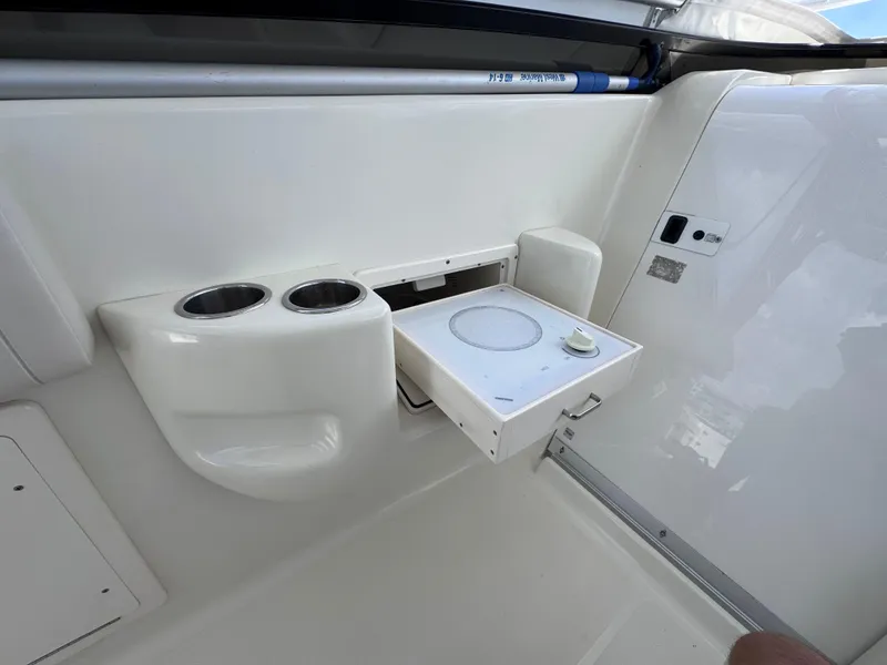 Slide: The Image of 2006 Hydra-Sports 33VX boat interior with cup holders and a fold-out table. - 17