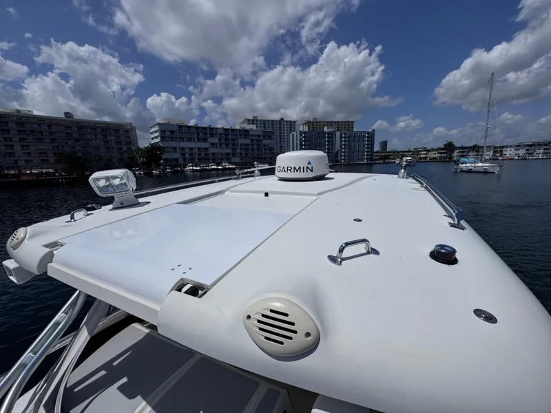 Slide: The Image of 2006 Hydra-Sports 33VX boat with Garmin equipment, docked in a marina under a cloudy sky. - 21