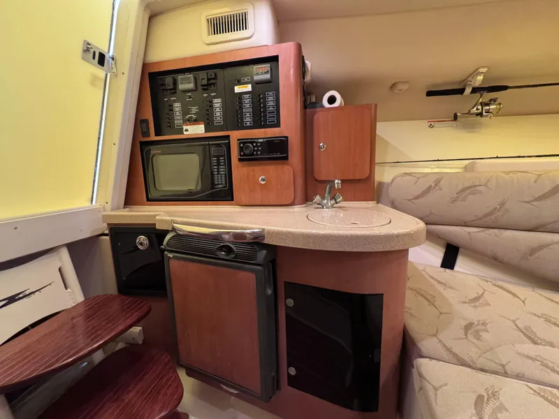 Slide: The Image of 2006 Hydra-Sports 33VX cabin interior with kitchenette, control panel, and seating area. - 22