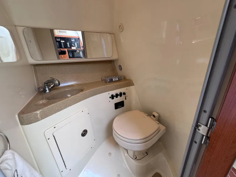 Slide: The Image of 2006 Hydra-Sports 33VX boat bathroom with sink, toilet, and control panel. - 26