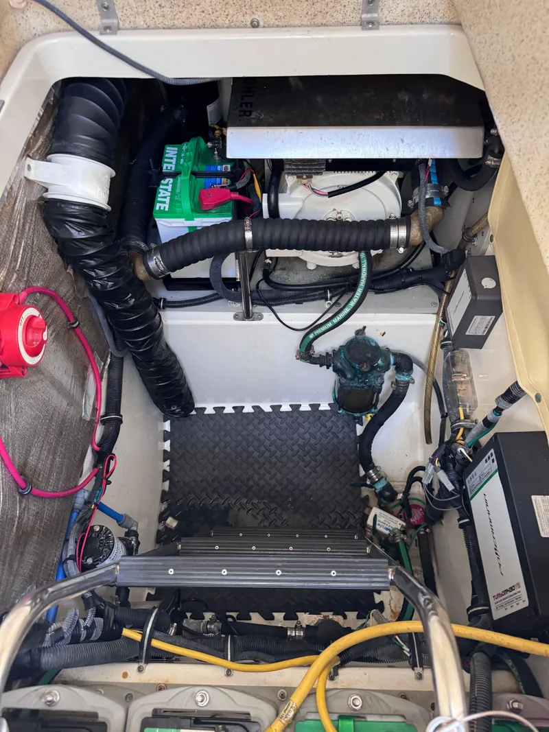 Slide: The Image of Engine compartment of a 2006 Hydra-Sports 33VX boat, showcasing wiring and components. - 27