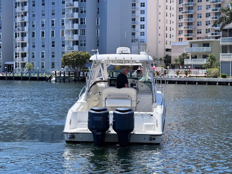 Slide: The Image of 2006 Hydra-Sports 33VX boat cruising near waterfront buildings. - 3