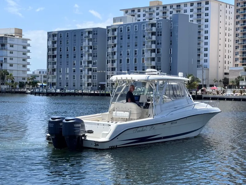 Slide: The Image of 2006 Hydra-Sports 33VX boat on water, cityscape background, clear sky. - 4