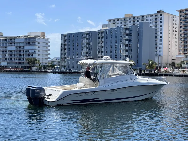 Slide: The Image of 2006 Hydra-Sports 33VX boat cruising on water with cityscape background. - 5