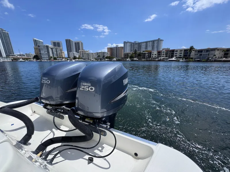 Slide: The Image of 2006 Hydra-Sports 33VX boat with twin Yamaha 250 engines on a sunny waterfront. - 8