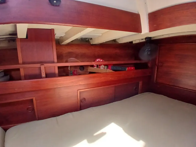 Slide: The Image of Cozy cabin interior of a 1977 Dickerson 41 sailboat with wooden furnishings. - 26