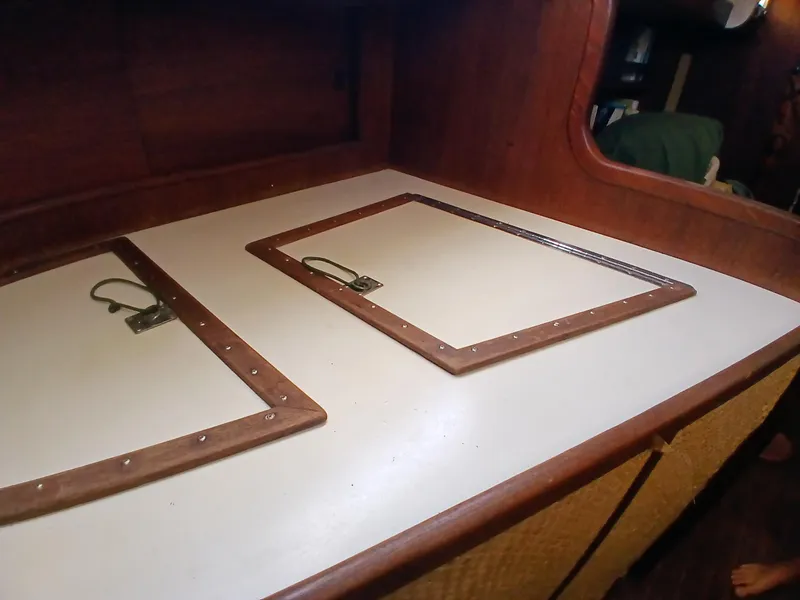 Slide: The Image of 1977 Dickerson 41 yacht interior with wooden storage compartments and latches. - 32