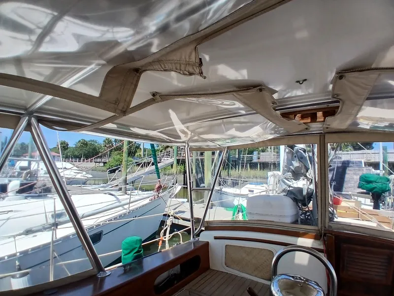 Slide: The Image of Interior view of a 1977 Dickerson 41 sailboat docked at a marina. - 38