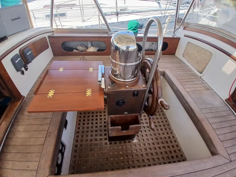 Slide: The Image of Cockpit of 1977 Dickerson 41 sailboat with wooden wheel and folding table. - 39
