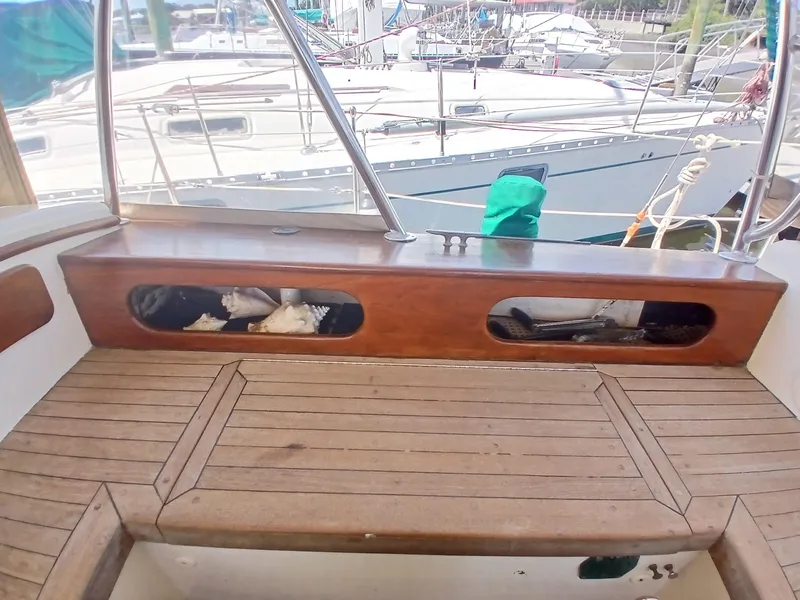 Slide: The Image of Wooden deck of a 1977 Dickerson 41 sailboat with storage compartments. - 41