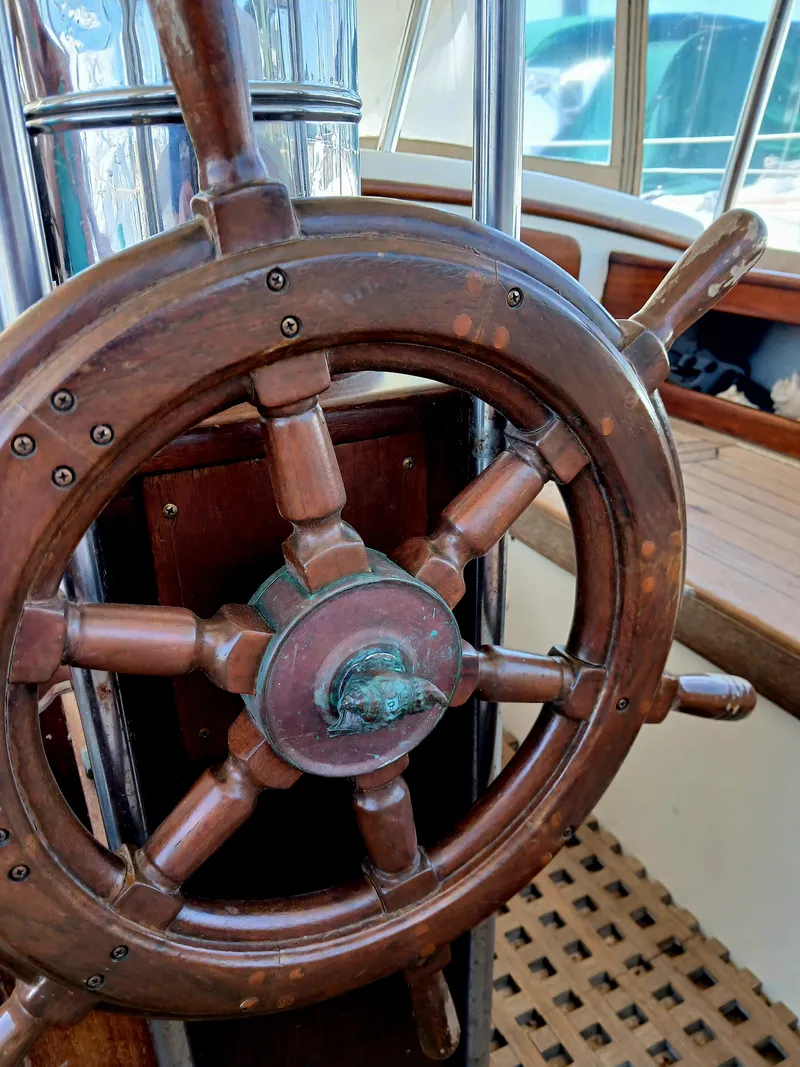 Slide: The Image of Vintage 1977 Dickerson 41 sailboat wooden steering wheel, showcasing classic nautical craftsmanship. - 44