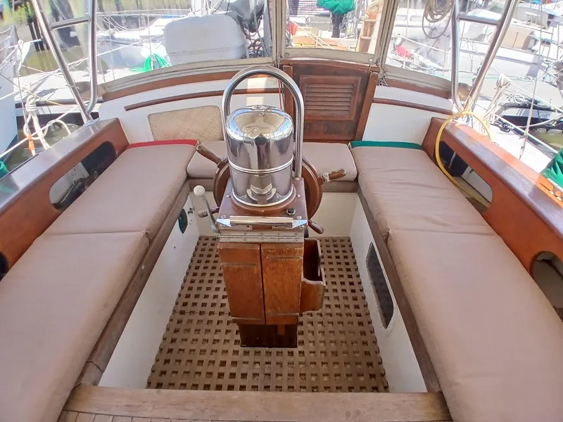 Slide: The Image of Cockpit of 1977 Dickerson 41 sailboat with wooden seating and steering wheel. - 46
