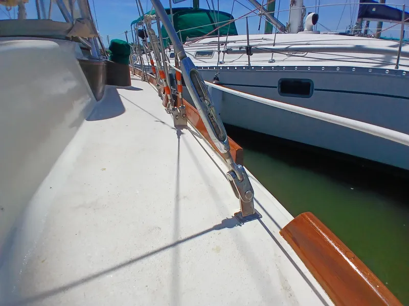 Slide: The Image of Deck view of a 1977 Dickerson 41 sailboat, showcasing rigging and wooden trim. - 49