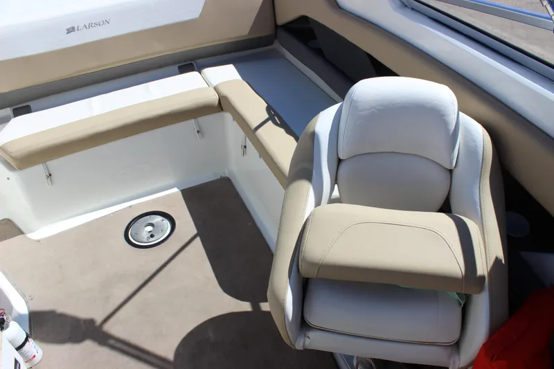 Slide: The Image of 2005 Larson LXi 268 boat interior with beige seating and steering chair. - 12