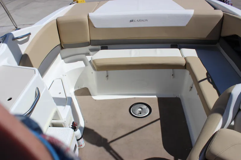 Slide: The Image of 2005 Larson LXi 268 boat interior with beige seating and white accents. - 13