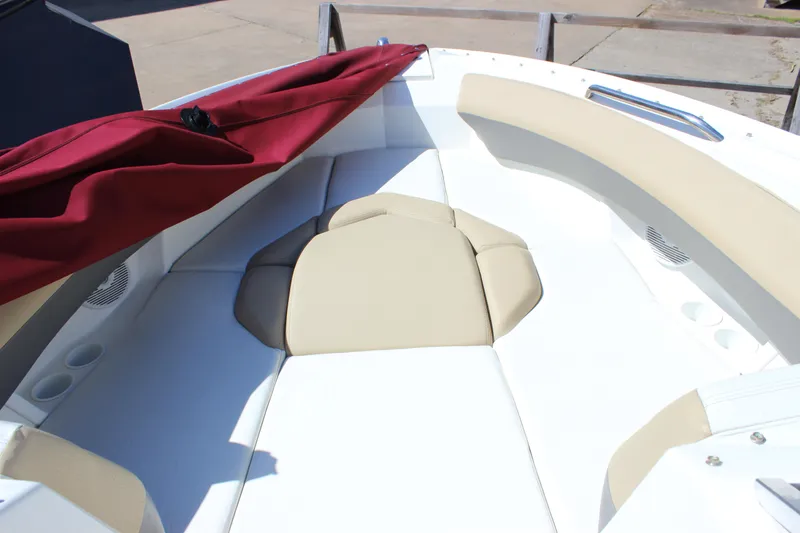 Slide: The Image of 2005 Larson LXi 268 boat interior with beige seating and red cover. - 17
