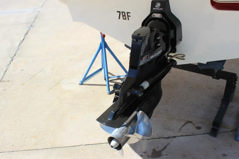 Slide: The Image of 2005 Larson LXi 268 boat with Mercury outboard motor on a stand. - 4