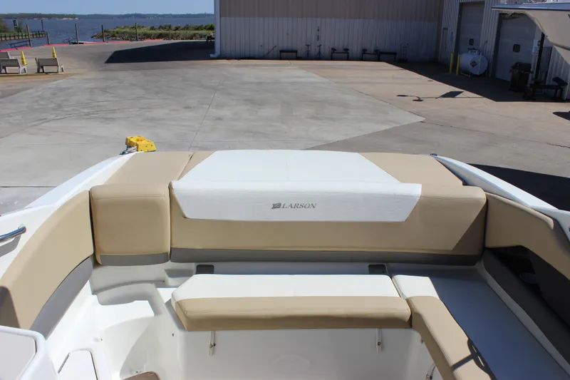 Slide: The Image of 2005 Larson LXi 268 boat interior with beige seating at a marina. - 7