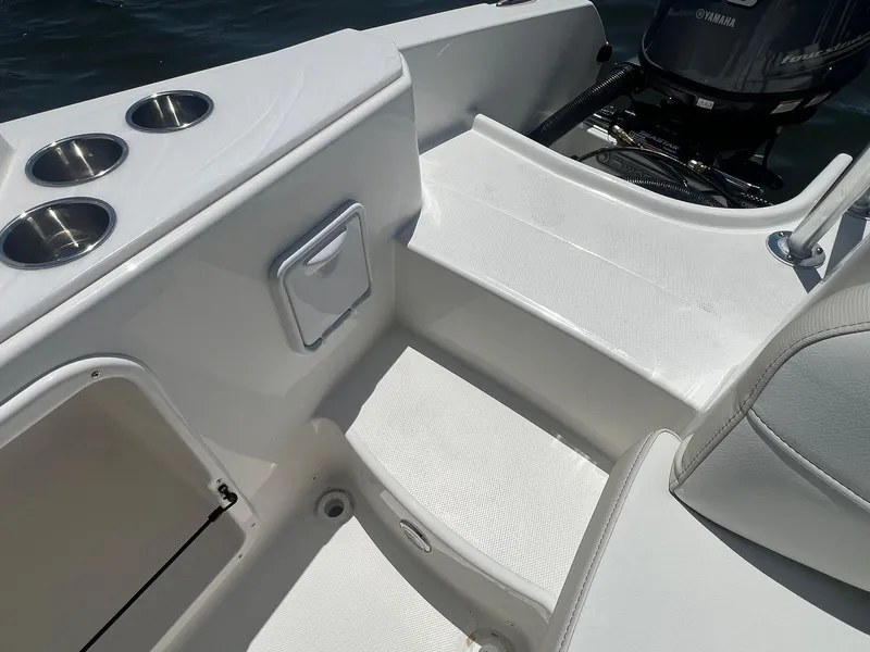 Slide: The Image of 2025 World Cat 230 SD boat interior with cup holders and seating area. - 13