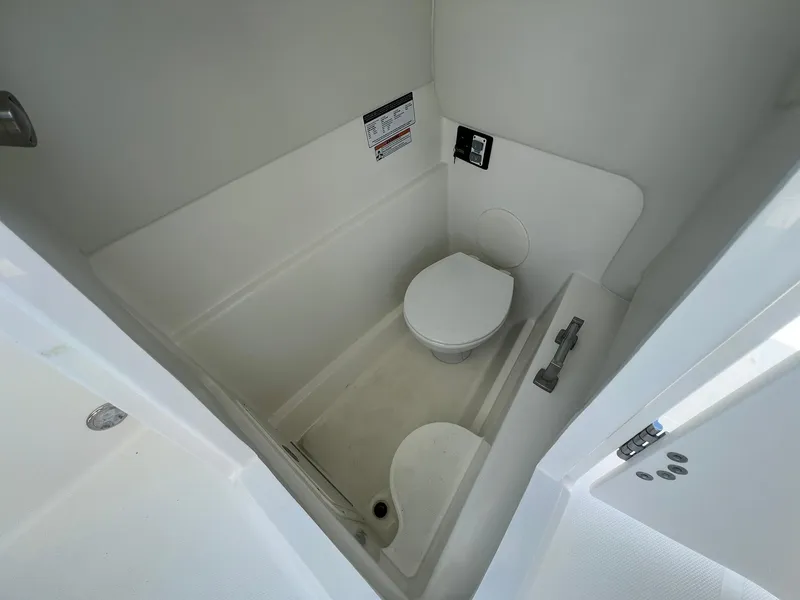 Slide: The Image of 2025 World Cat 230 SD boat interior bathroom with toilet and shower. - 17