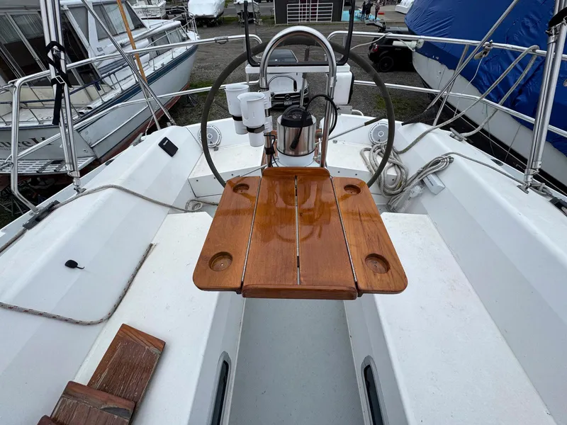 Slide: The Image of Cockpit of 1989 Catalina 42 MkII sailboat with wooden table and steering wheel. - 10
