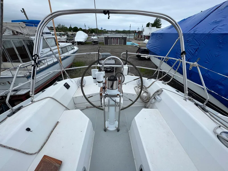 Slide: The Image of Cockpit view of a 1989 Catalina 42 MkII sailboat in a marina. - 11