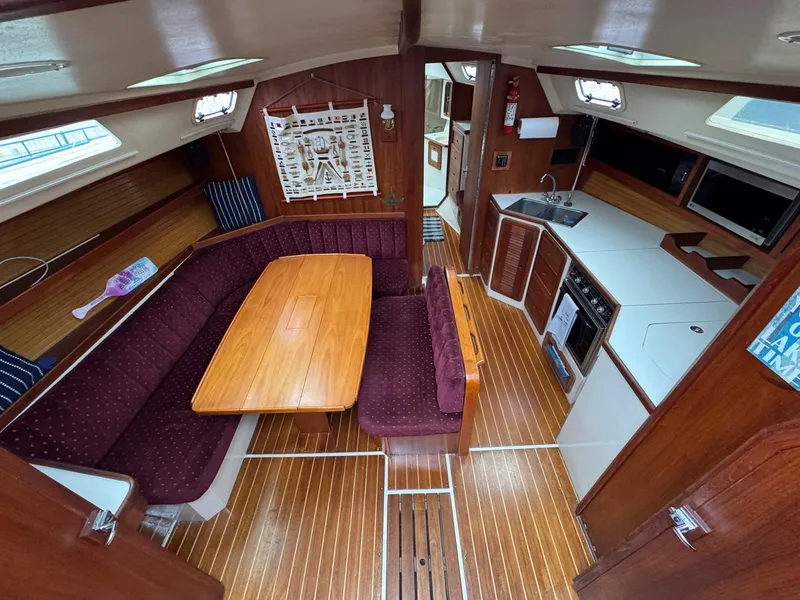 Slide: The Image of Interior of 1989 Catalina 42 MkII sailboat with wood finish and cozy seating area. - 15