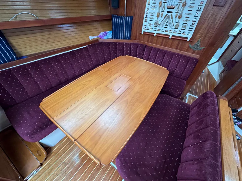 Slide: The Image of Interior of 1989 Catalina 42 MkII sailboat with wooden table and maroon seating. - 20