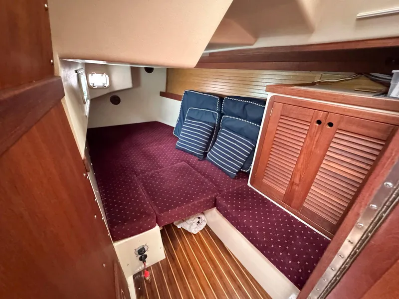 Slide: The Image of Interior cabin of 1989 Catalina 42 MkII sailboat with red upholstery and wooden accents. - 24