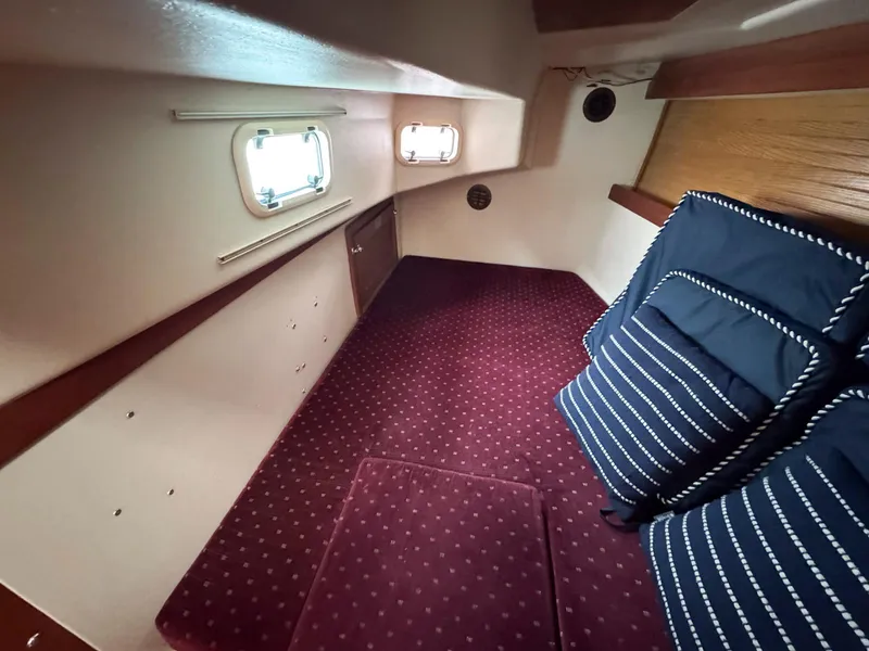 Slide: The Image of Interior cabin of 1989 Catalina 42 MkII with maroon carpet and striped cushions. - 25