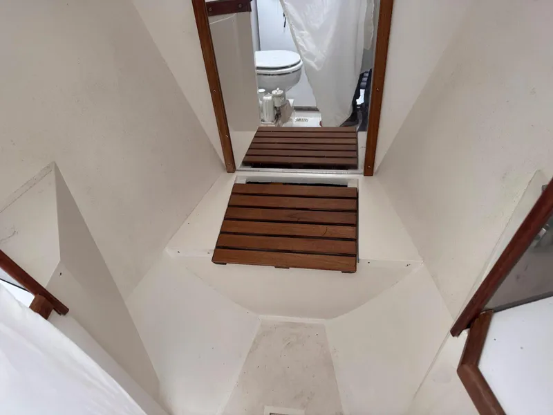 Slide: The Image of Interior of 1989 Catalina 42 MkII sailboat, featuring wooden flooring and compact bathroom. - 31