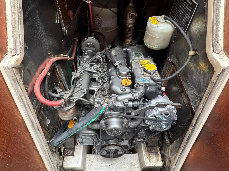 Slide: The Image of Engine compartment of a 1989 Catalina 42 MkII sailboat, showcasing detailed mechanical components. - 33