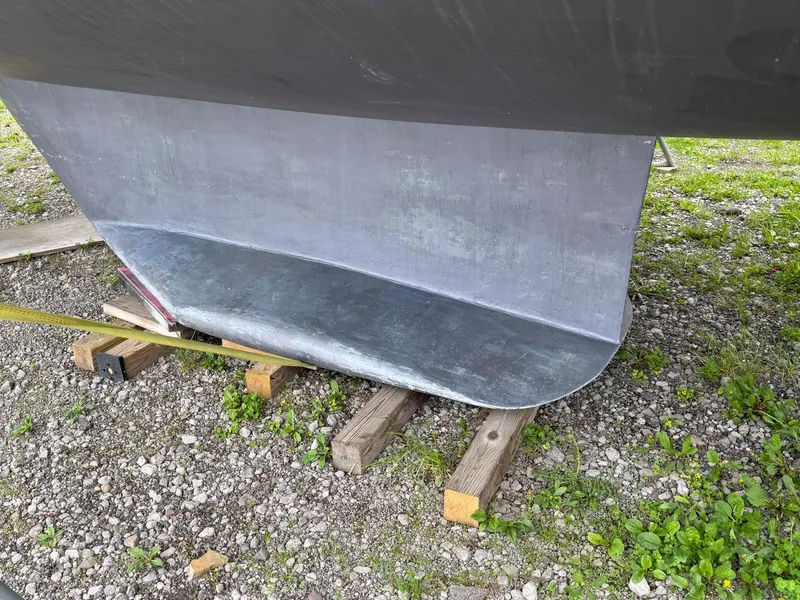 Slide: The Image of Catalina 42 MkII 1989 sailboat keel resting on wooden blocks outdoors. - 4