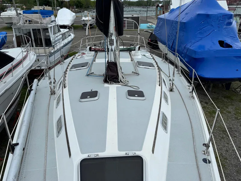 Slide: The Image of 1989 Catalina 42 MkII sailboat deck view, docked among other boats. - 9