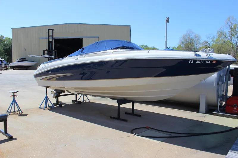 The Image of 2001 Sea Ray 260 Sundeck boat on dry dock, covered and elevated. - 0